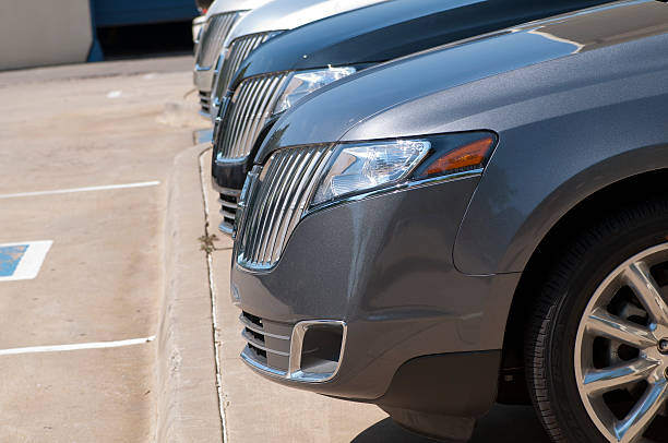 A row of parked cars in a parking lot, featuring vehicles from a Limo Rental Service.