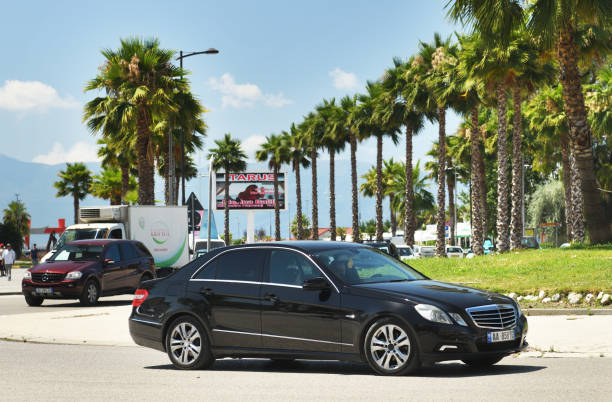 Mercedes-Benz E-Class parked in a city setting, promoting a luxury limo rental service.