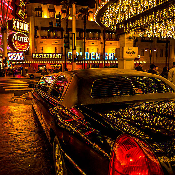 A sleek black limousine, marked 'Private Limo', parked on a dimly lit street at night.
