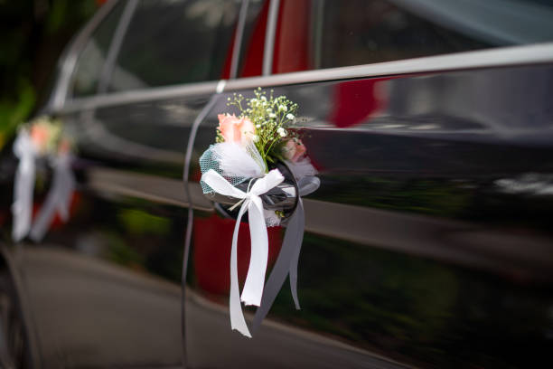 A bride and groom celebrate in a limo, holding champagne flutes, with a sign reading "Limo for Your Anniversary" visible.
