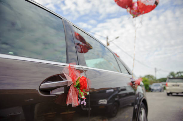 Inside a limo, a bride and groom toast with champagne flutes, celebrating their anniversary with joy and elegance.